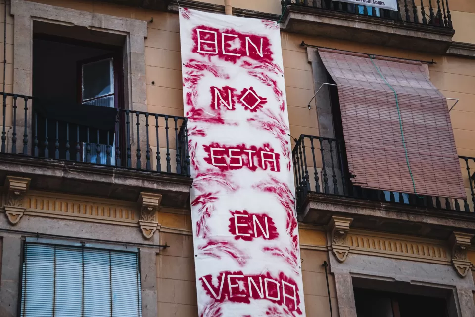 Hand painted fabric "Barcelona is not for sale" in Spanish banner hung on a building in Barcelona, Spain